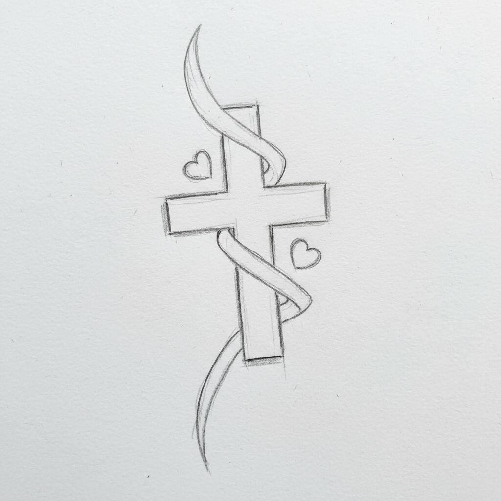 Desenho de uma cruz decorada com laços e corações